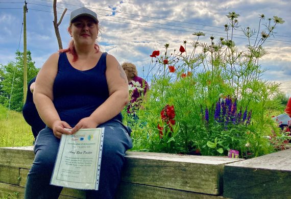 woman sitting next to garden