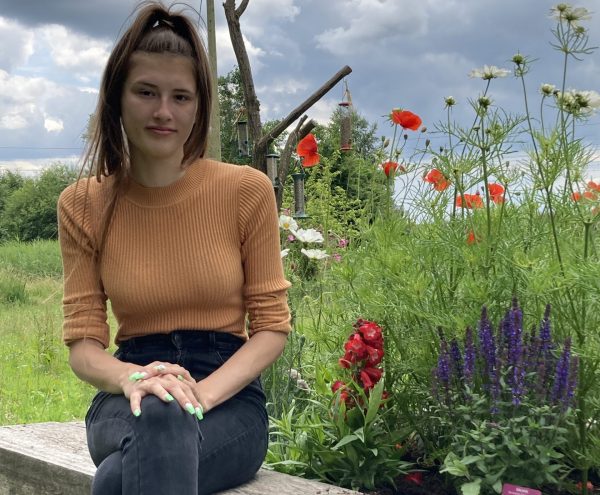 woman next to flowers